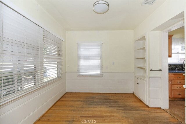 2046 E Glenoaks Blvd, Glendale, CA 91206 - unfurnished dining area with light wood-type flooring and wainscoting
