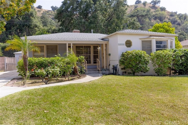 2046 E Glenoaks Blvd, Glendale, CA 91206 - view of front of home featuring a front lawn, a mountain view, stucco siding, a gate, and a chimney
