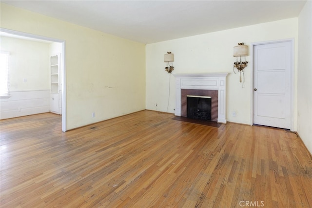2046 E Glenoaks Blvd, Glendale, CA 91206 - unfurnished living room with light wood-type flooring and a brick fireplace