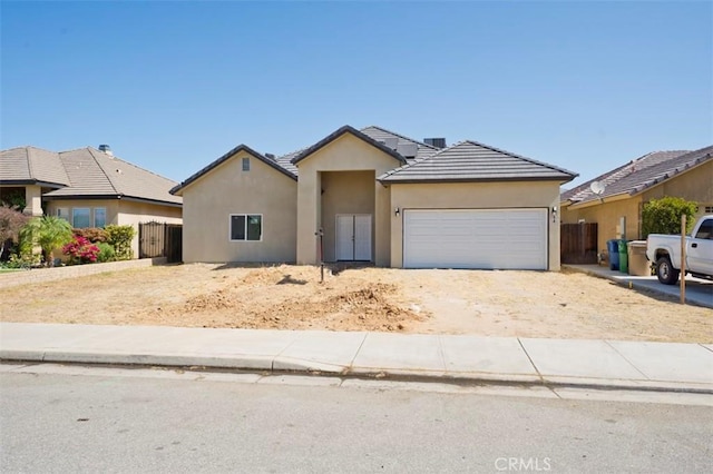 540 Shady Meadow Ct, Bakersfield, CA 93308 - view of front of home featuring a garage, stucco siding, dirt driveway, and a tiled roof
