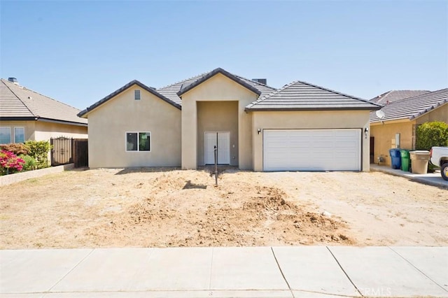 540 Shady Meadow Ct, Bakersfield, CA 93308 - view of front of house with a garage, stucco siding, dirt driveway, and a tiled roof
