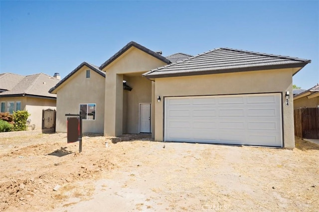 540 Shady Meadow Ct, Bakersfield, CA 93308 - view of front facade featuring stucco siding, a garage, dirt driveway, and a tile roof
