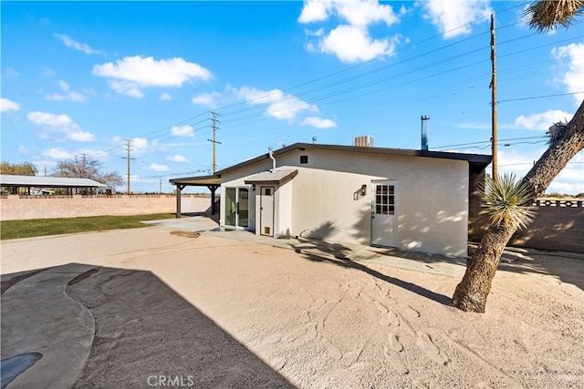41331 20th St W, Palmdale, CA 93551 - rear view of house featuring stucco siding, a patio, and a fenced backyard
