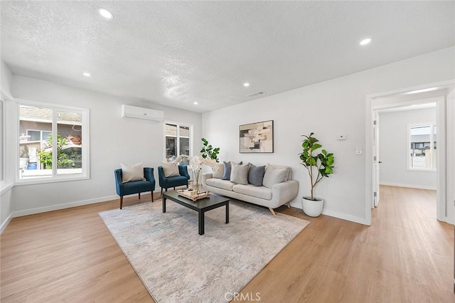 1021 W 5th St, Corona, CA 92882 - living area featuring a wall mounted AC, a textured ceiling, light wood finished floors, and recessed lighting