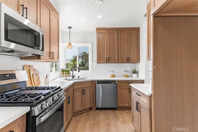 1021 W 5th St, Corona, CA 92882 - kitchen featuring appliances with stainless steel finishes, light wood finished floors, light countertops, and backsplash