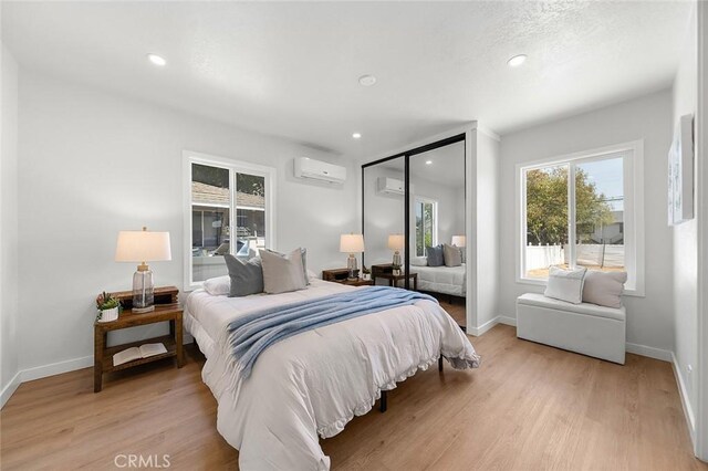 1021 W 5th St, Corona, CA 92882 - bedroom with a wall mounted air conditioner, light wood finished floors, recessed lighting, and a closet