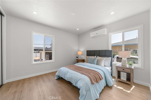 1021 W 5th St, Corona, CA 92882 - bedroom featuring a wall unit AC, light wood-type flooring, and recessed lighting