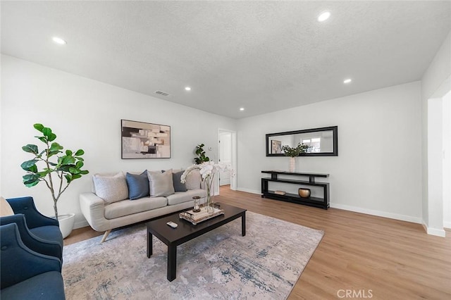 1021 W 5th St, Corona, CA 92882 - living area featuring light wood-style floors, a textured ceiling, and recessed lighting