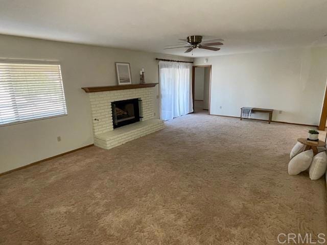 1003 Amherst Ave, Hemet, CA 92544 - unfurnished living room with carpet flooring, ceiling fan, and a brick fireplace
