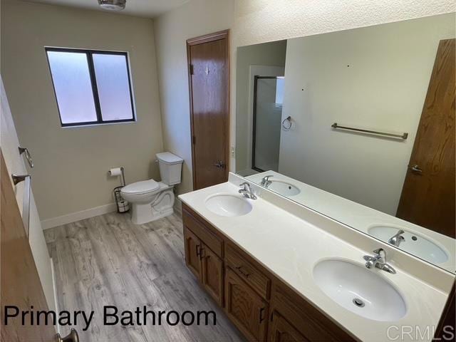 1003 Amherst Ave, Hemet, CA 92544 - bathroom with wood finished floors, an enclosed shower, and double vanity