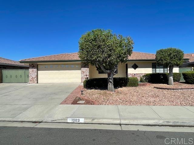 1003 Amherst Ave, Hemet, CA 92544 - view of front facade featuring driveway, an attached garage, and stucco siding