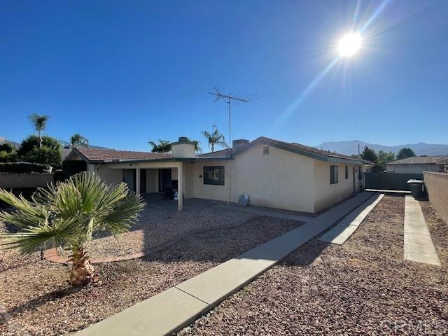 1003 Amherst Ave, Hemet, CA 92544 - view of front facade featuring stucco siding, a mountain view, and a patio area