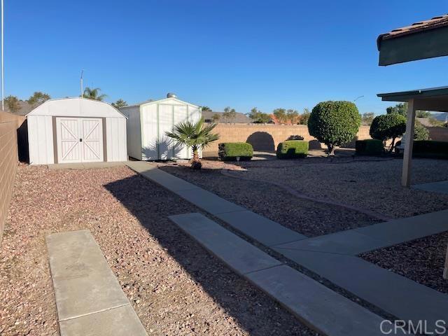 1003 Amherst Ave, Hemet, CA 92544 - fenced backyard featuring a storage unit