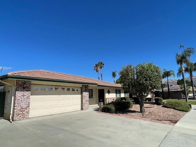 1003 Amherst Ave, Hemet, CA 92544 - ranch-style home featuring a garage, concrete driveway, and brick siding