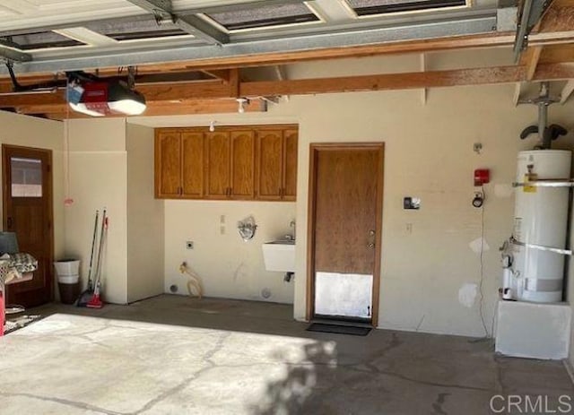 1003 Amherst Ave, Hemet, CA 92544 - garage with secured water heater and a garage door opener