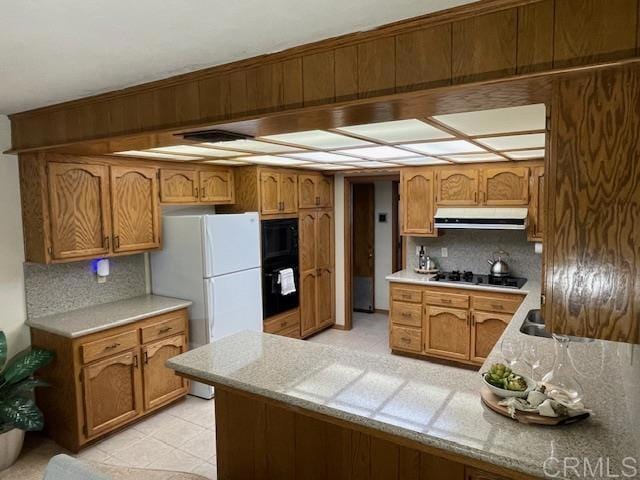 1003 Amherst Ave, Hemet, CA 92544 - kitchen featuring black appliances, under cabinet range hood, decorative backsplash, and a peninsula