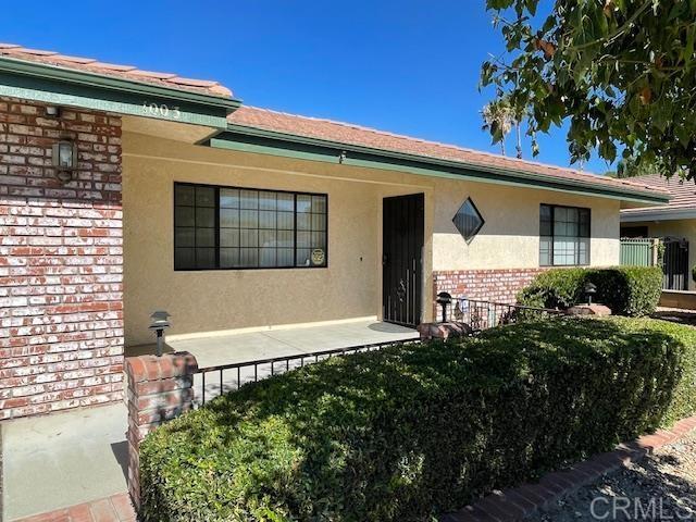 1003 Amherst Ave, Hemet, CA 92544 - view of exterior entry with brick siding and stucco siding