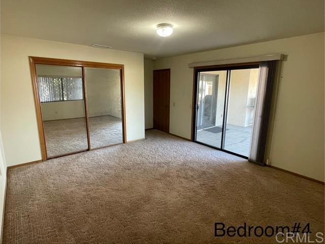 1003 Amherst Ave, Hemet, CA 92544 - unfurnished bedroom with light colored carpet and baseboards