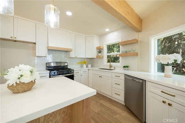 31303 Marcella Dr, Running Springs, CA 92382 - kitchen featuring appliances with stainless steel finishes, custom exhaust hood, light wood finished floors, tasteful backsplash, and open shelves