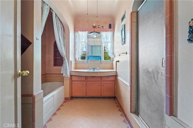 100 E Buena Vista St, Barstow, CA 92311 - bathroom with vanity, a stall shower, a garden tub, and tile patterned floors