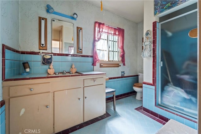 100 E Buena Vista St, Barstow, CA 92311 - bathroom with tile walls, vanity, a stall shower, a wainscoted wall, and tile patterned flooring