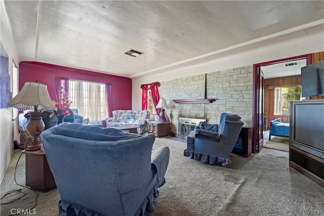 100 E Buena Vista St, Barstow, CA 92311 - carpeted living area featuring a fireplace