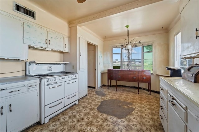 100 E Buena Vista St, Barstow, CA 92311 - kitchen featuring white gas range, light flooring, a chandelier, white cabinetry, and light countertops