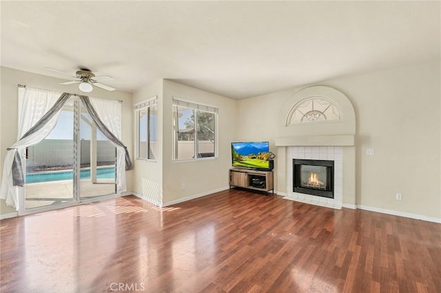 44601 Jamin Cir, Temecula, CA 92592 - unfurnished living room featuring plenty of natural light, a ceiling fan, wood finished floors, and a fireplace