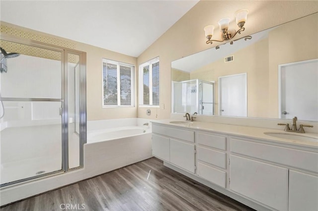 44601 Jamin Cir, Temecula, CA 92592 - full bath featuring lofted ceiling, a stall shower, a bath, wood finished floors, and double vanity