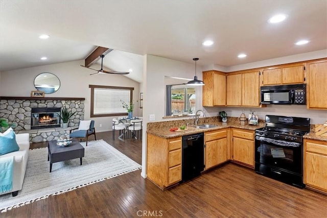 2266 Mcneil Cir, Corona, CA 92882 - kitchen featuring black appliances, open floor plan, dark wood finished floors, light stone counters, and a fireplace