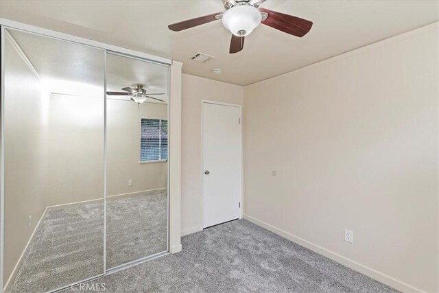 2266 Mcneil Cir, Corona, CA 92882 - unfurnished bedroom featuring carpet floors, a closet, and ceiling fan
