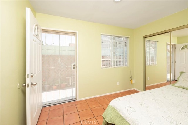1203 E 33rd St, Los Angeles, CA 90011 - tiled bedroom featuring baseboards and a closet