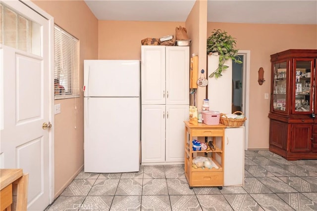 1203 E 33rd St, Los Angeles, CA 90011 - kitchen with freestanding refrigerator and white cabinets