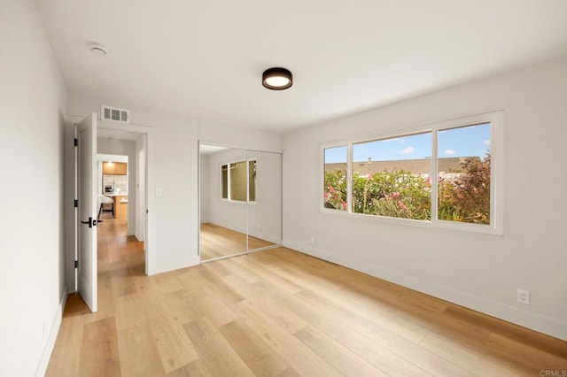113 Via Breve Unit 23, San Clemente, CA 92672 - unfurnished bedroom with light wood-type flooring and a closet