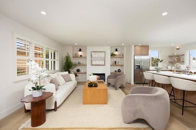 113 Via Breve Unit 23, San Clemente, CA 92672 - living area featuring recessed lighting, a lit fireplace, and light wood-style floors