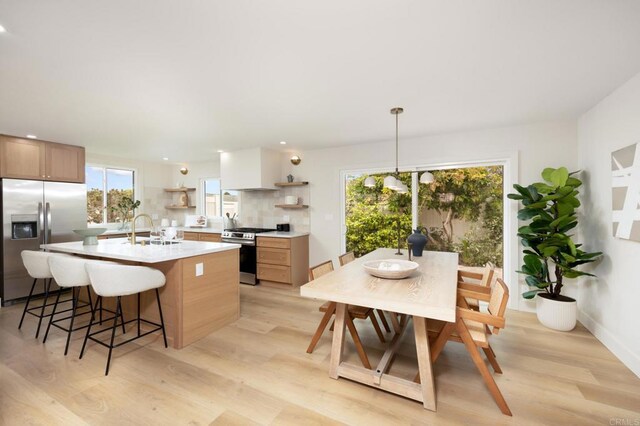 113 Via Breve Unit 23, San Clemente, CA 92672 - kitchen featuring appliances with stainless steel finishes, open shelves, light countertops, light wood finished floors, and recessed lighting