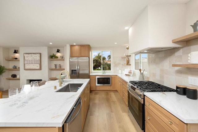 113 Via Breve Unit 23, San Clemente, CA 92672 - kitchen with open shelves, stainless steel appliances, light wood-type flooring, a large island, and tasteful backsplash