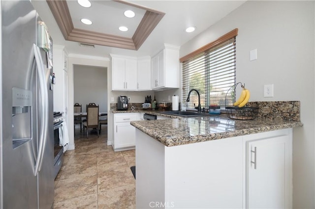 25165 Pebble Creek Way, Moreno Valley, CA 92551 - kitchen featuring appliances with stainless steel finishes, a peninsula, a raised ceiling, stone countertops, and white cabinets