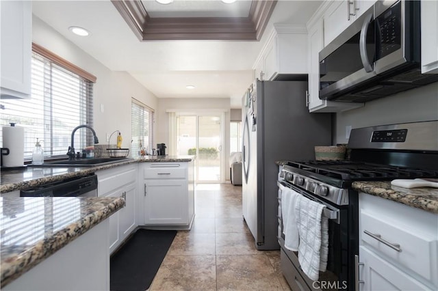 25165 Pebble Creek Way, Moreno Valley, CA 92551 - kitchen with stainless steel appliances, white cabinetry, a raised ceiling, stone counters, and crown molding
