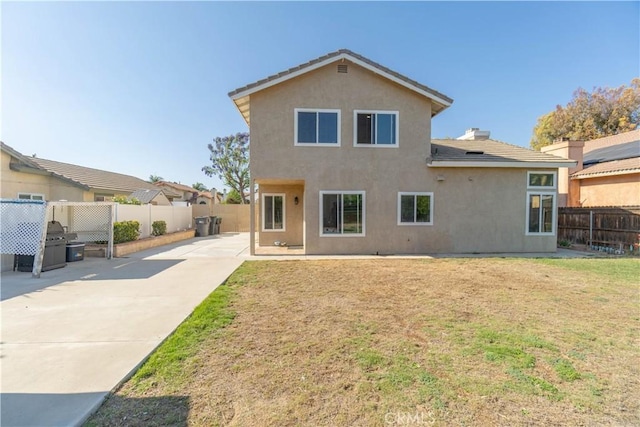 25165 Pebble Creek Way, Moreno Valley, CA 92551 - back of property with stucco siding, a fenced backyard, a patio area, and concrete driveway