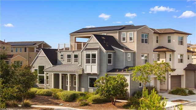 125 Character, Irvine, CA 92618 - rear view of property with an attached garage, a standing seam roof, a residential view, concrete driveway, and a metal roof