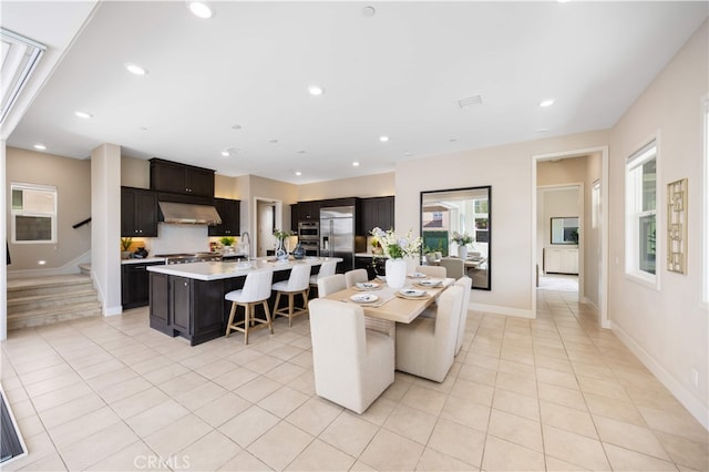 125 Character, Irvine, CA 92618 - kitchen featuring high quality fridge, light countertops, light tile patterned floors, a breakfast bar, and recessed lighting