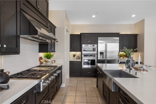 125 Character, Irvine, CA 92618 - kitchen featuring appliances with stainless steel finishes, light countertops, light tile patterned floors, under cabinet range hood, and recessed lighting