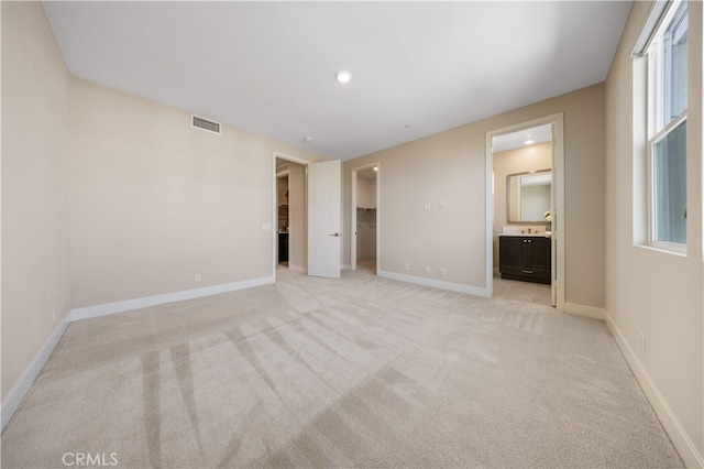 125 Character, Irvine, CA 92618 - unfurnished bedroom featuring light colored carpet, a spacious closet, ensuite bathroom, and multiple windows