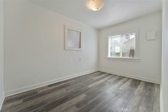 5868 Estrella Ave, Los Angeles, CA 90044 - empty room featuring dark wood-type flooring and baseboards