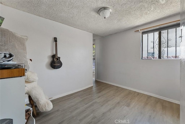5868 Estrella Ave, Los Angeles, CA 90044 - empty room featuring wood finished floors and a textured ceiling