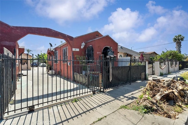 5868 Estrella Ave, Los Angeles, CA 90044 - view of front facade featuring a fenced front yard, stucco siding, and a gate