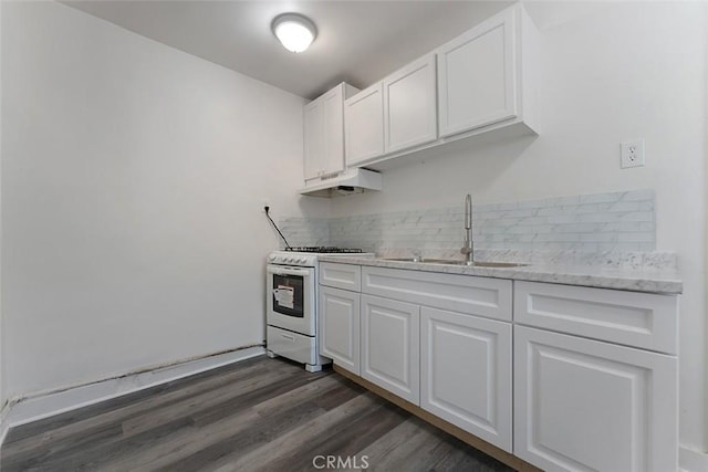 5868 Estrella Ave, Los Angeles, CA 90044 - kitchen featuring white gas range, under cabinet range hood, white cabinets, and backsplash