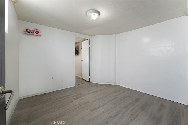 5868 Estrella Ave, Los Angeles, CA 90044 - spare room with wood finished floors and a textured ceiling