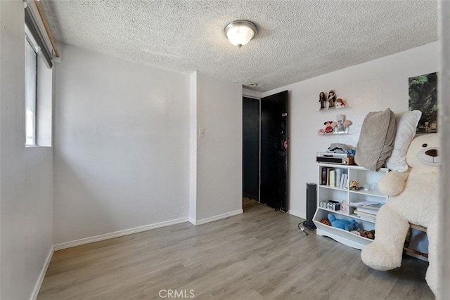 5868 Estrella Ave, Los Angeles, CA 90044 - unfurnished room featuring a textured ceiling and wood finished floors